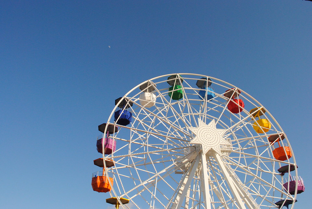 A fairground ferris wheel against the evening sky